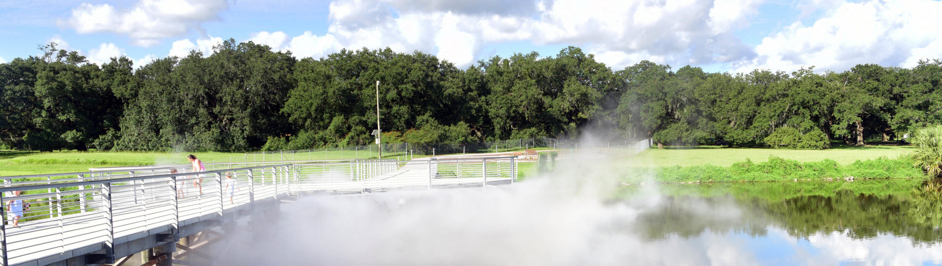 Misty cloud overlooking the lagoon and footbridge at the entrance